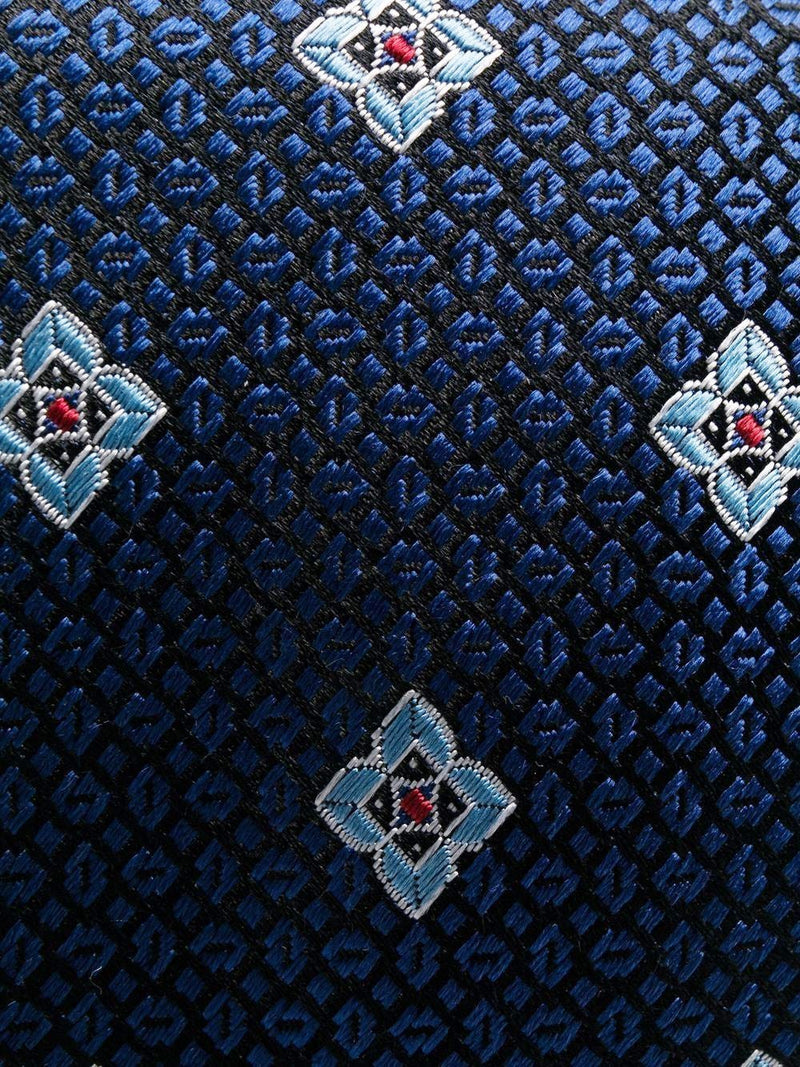 Corbata azul marino con flores geométricas